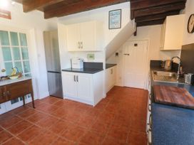 A kitchen with cabinets and appliances at Halwyn Farm in Helston