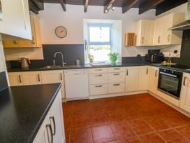 A kitchen with a sink and appliances at Halwyn Farm in Helston