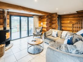 A living room with log walls and a coffee table at The Lookout in Addingham