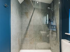 A shower area with tiles and shower fixtures at The Lookout in Addingham