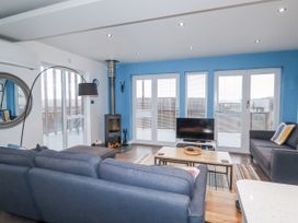 A living room with a sofa and TV at Pentewan in Redruth