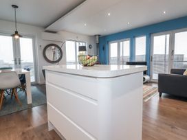 A kitchen with a dining table and chairs at Pentewan in Redruth
