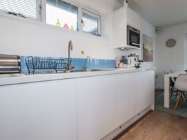 A kitchen with sink and appliances at Pentewan in Redruth