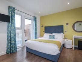 A bedroom with a bed and television at Pentewan in Redruth