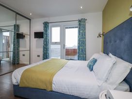 A bedroom with a bed and mirror at Pentewan Redruth