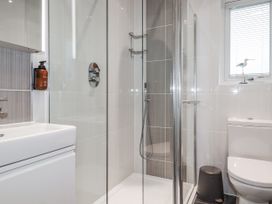 A bathroom with a shower and sink at Pentewan in Redruth