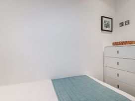 A bedroom with a bed and drawers at Pentewan Redruth