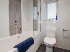 A bathroom featuring a bath tub and toilet at Pentewan in Redruth