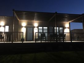 An outdoor area with a deck and furniture at Pentewan in Redruth