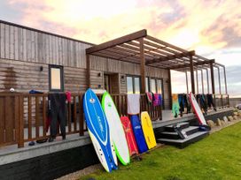 A house with surfboards and wetsuits on the deck at Pentewan Redruth