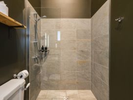 A shower area with tiles and a toilet at Bears Den in Addingham