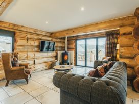 A living room with a sofa and armchair at Keepers Cabin in Addingham