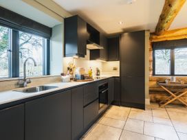 A kitchen with cabinets and a sink at Keepers Cabin in Addingham