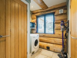 A laundry room with a washing machine and window at Keepers Cabin Addingham