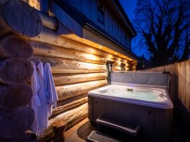 An outdoor hot tub next to wooden wall at Keepers Cabin Addingham