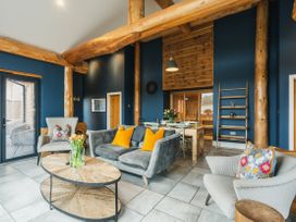 A living room with a coffee table and dining area at The Farmhouse in Addingham