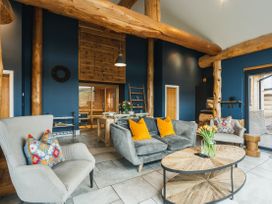 A living room with a sofa and chairs near a coffee table at The Farmhouse in Addingham