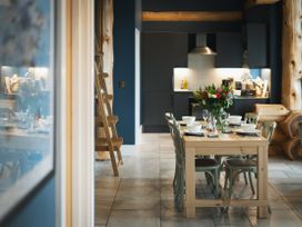 A kitchen with a dining table and chairs at The Farmhouse in Addingham