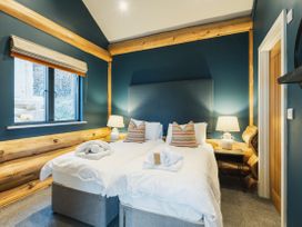 A bedroom with two beds and a window at The Farmhouse in Addingham