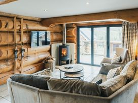 A living room with a fireplace and a sofa at Apres Ski in Addingham