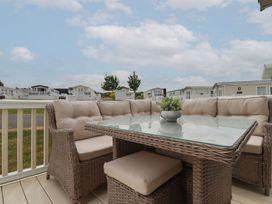 An outdoor seating area with a table and couch at No. 4 Fistral Newquay