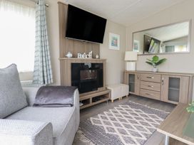 A living room with a television and a sofa at No. 4 Fistral in Newquay
