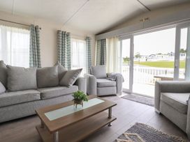 A living room with sofas and a coffee table at No. 4 Fistral in Newquay