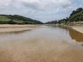 A river with sandbanks and green hills at No. 4 Fistral, Newquay