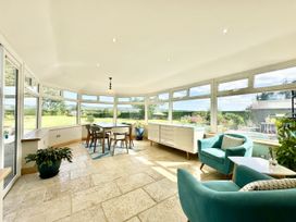 A conservatory with a table and chairs at Seeview in Charleville