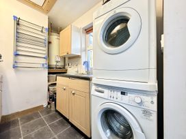 A utility room with a washing machine and tumble dryer at Seeview in Charleville
