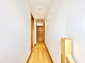 A hallway with wooden floor and doors at Seeview in Charleville