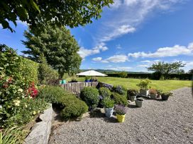 A garden with planters and a table under an umbrella at Seeview, Charleville