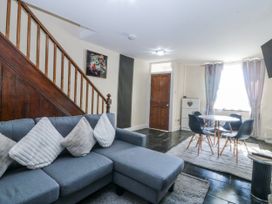 A living room with a sofa and table at Tegfan in Garndolbenmaen near Porthmadog