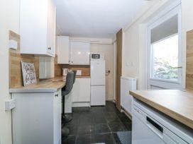 A kitchen with appliances and a window at Tegfan in Garndolbenmaen near Porthmadog