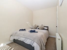 A bedroom with a bed and pillows at Tegfan in Garndolbenmaen near Porthmadog