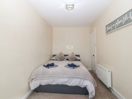 A bedroom with a bed and pillows at Tegfan in Garndolbenmaen near Porthmadog