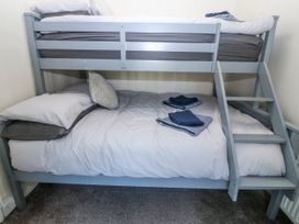 A bunk bed with pillows and towels in a bedroom at Tegfan, Garndolbenmaen near Porthmadog