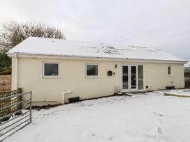 A house exterior with snow at Swallow Cottage in Llangefni