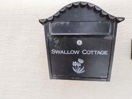 A mailbox with the name Swallow Cottage at Swallow Cottage in Llangefni