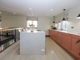 A kitchen with island and appliances at Bell House in Llanfechell