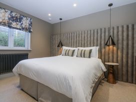 A bedroom with a bed and bedside table at Bell House in Llanfechell