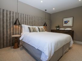 A bedroom with a bed and bedside table at Bell House in Llanfechell