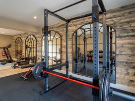 A gym with a power rack and treadmill at Bell House in Llanfechell