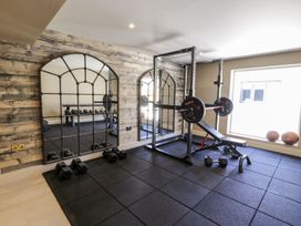A gym with dumbbells and a weight bench at Bell House in Llanfechell
