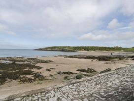 A beach with sand and water at Bell House in Llanfechell