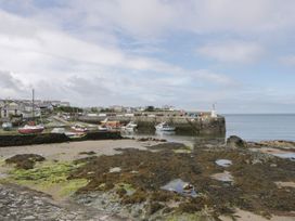 A view of a harbor with boats near the shore at Bell House in Llanfechell