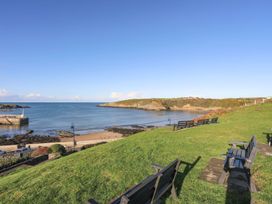 A beach with benches and sea at Bell House in Llanfechell