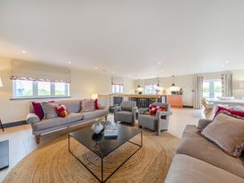 A living room with a sofa and armchairs at Bell House in Llanfechell