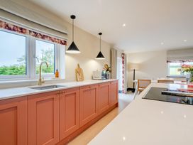 A kitchen with a sink and cabinets at Bell House in Llanfechell