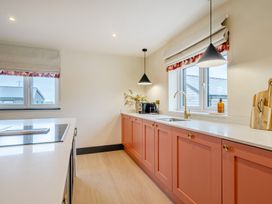 A kitchen with cabinets and appliances at Bell House in Llanfechell